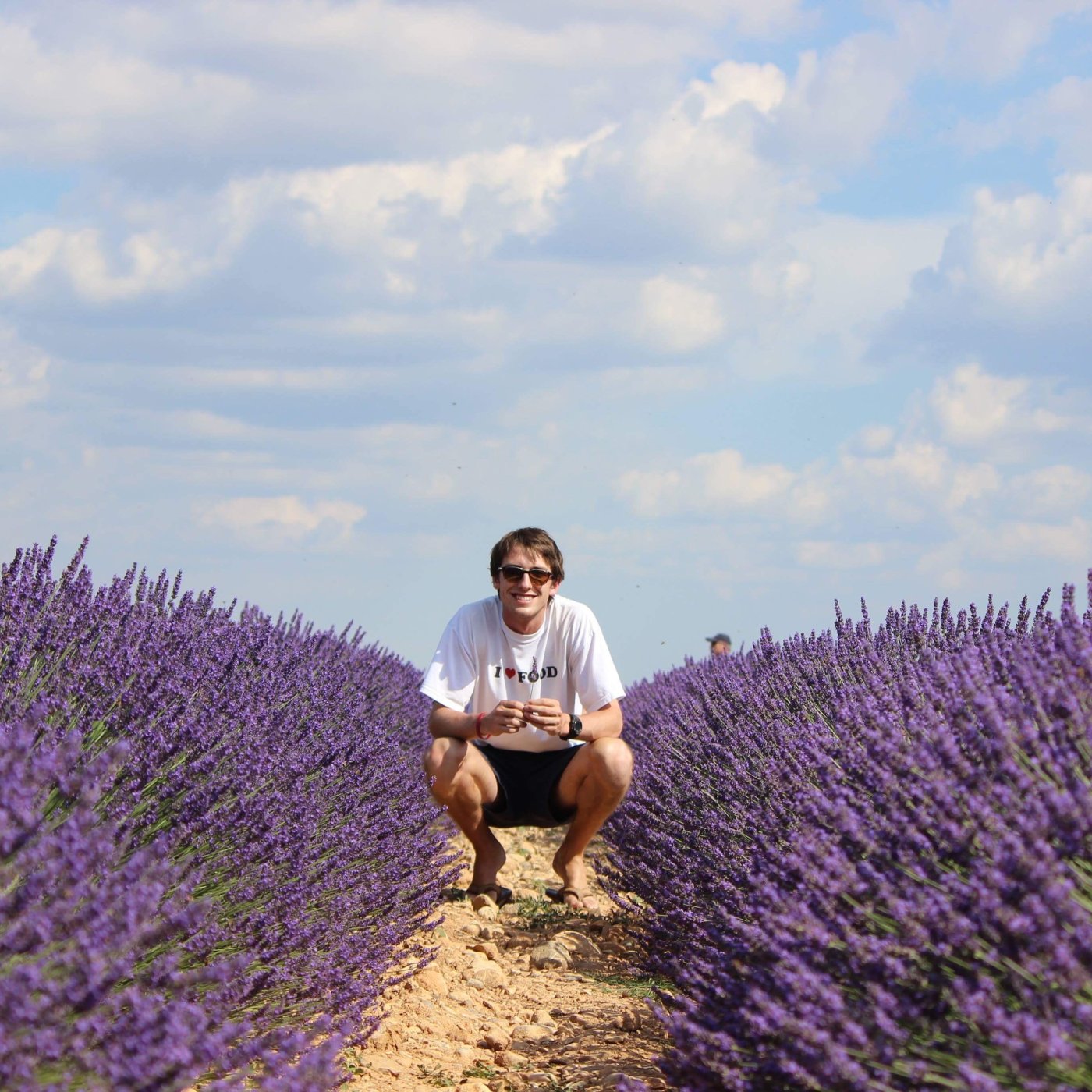 Student kneeling in lavender field in France