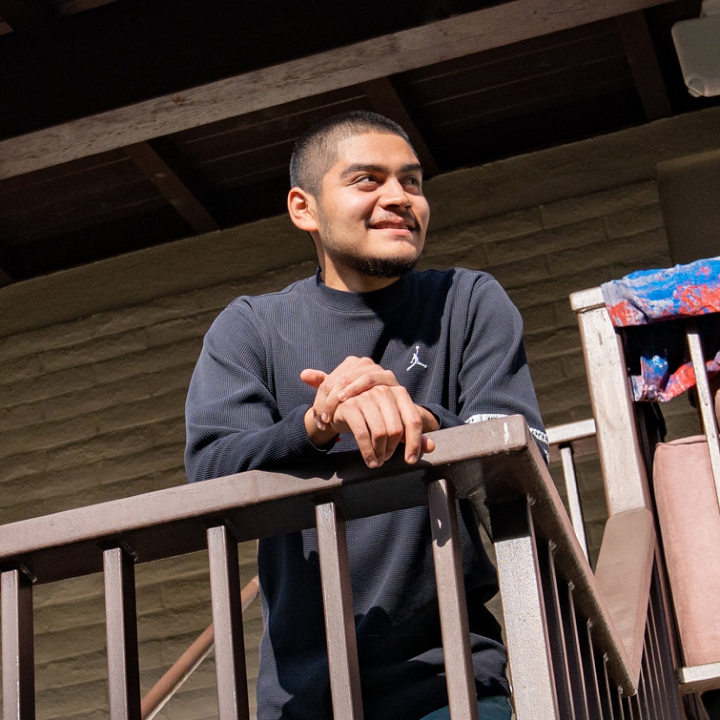 First-generation student Mat Escalante on the balcony of Guerrieri East, his residence hall