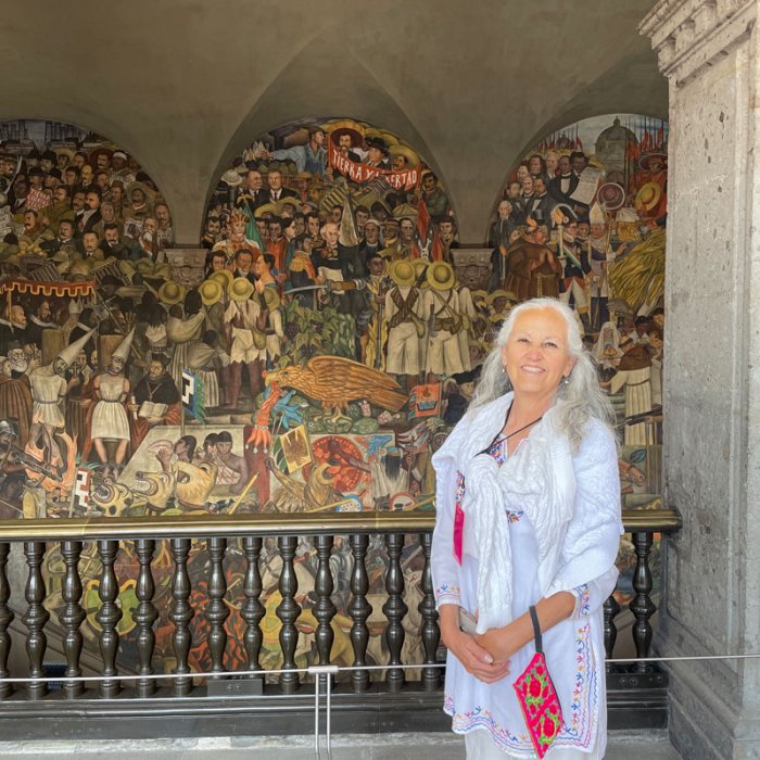 Professor Santiago in front of decorative wall