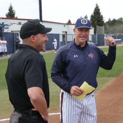 SMC Baseball Coach Greg Moore meets with the umpires before a game