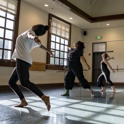 Three MFA students dancing in studio