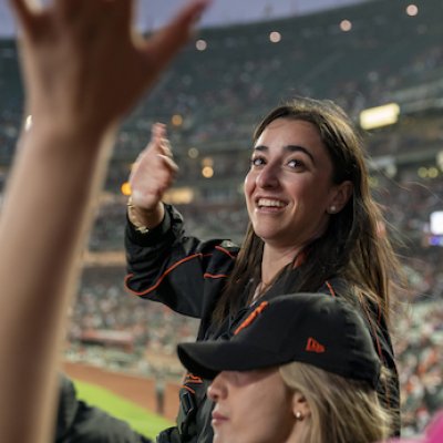 A student smiles at the SF Giants baseball game