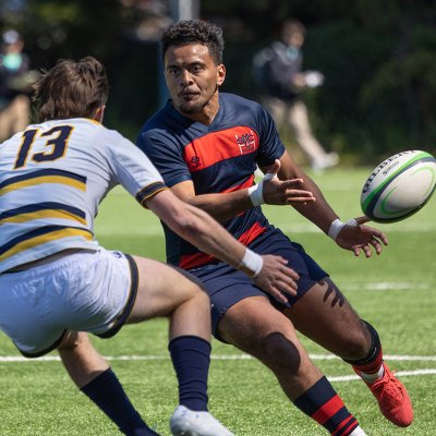 Saint Mary's Men's Rugby player Inoke Waqavesi runs past a UC Berkeley player on March 25, 2023