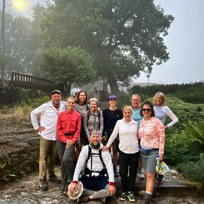 A group smiling on a misty morning on the Spanish Camino