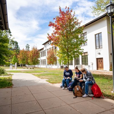 students sitting on bench at SMC