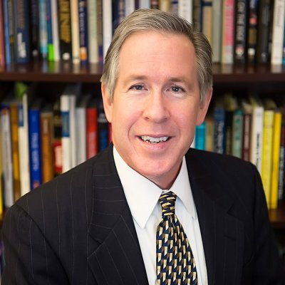 SEBA Dean Gibson with a screened image of the SMC Campus behind him