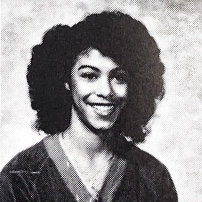 Headshot of Vicki Martin Smith '83 against a backdrop of the SMC campus