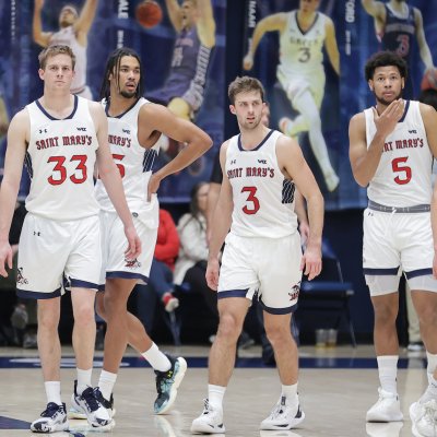 Five men's basketball players walking onto court against LMU in January 2024