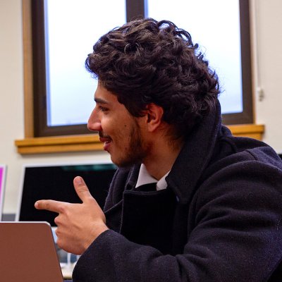 Debate students Jasper Pacheco ’27 and Luis Mora ’27 at a table, spring 2024
