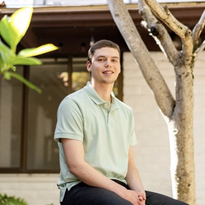Andrew Aroutynov '24 posed outside SEBA building