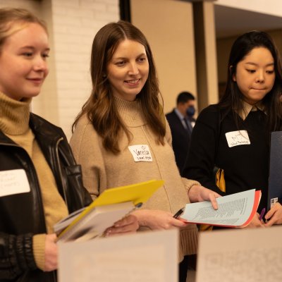 Three students talk with a recruiter at the KSOE Career Fair in February 2025