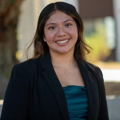Photo of student Rose Velasquez with a blue patterned background