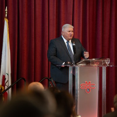 Roger at State of the College podium