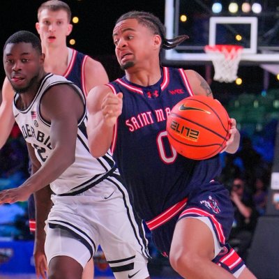 Basketball player Mikey Lewis drives against Vanderbilt in November 2025
