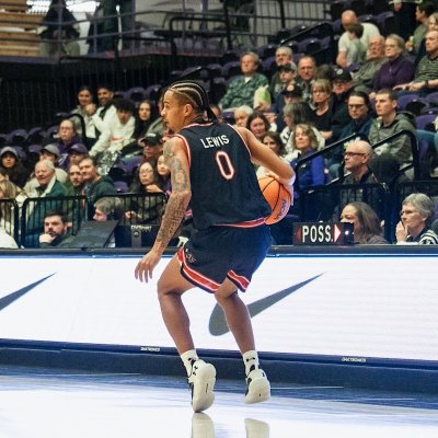 Basketball player Mikey Lewis drives against Portland in January 2026