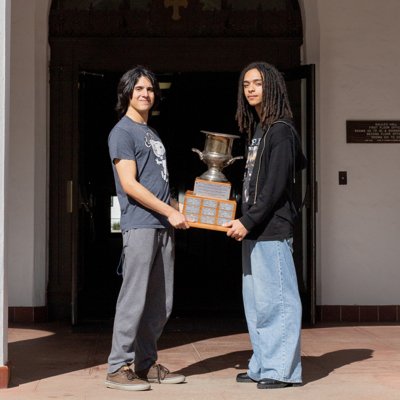 Adrian Lossada and Jasper Pacheco pose with the trophy on campus