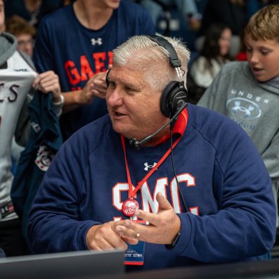 SMC President Roger Thompson talks with ESPN+ commentator Brian Brownfield at a Veterans Day Basketball Game