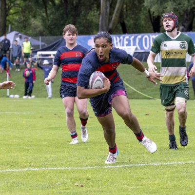 Men's Rugby student-athlete Molitika Santiago Ix-Siu runs past the Colorado State defender in an attempt to score a try.