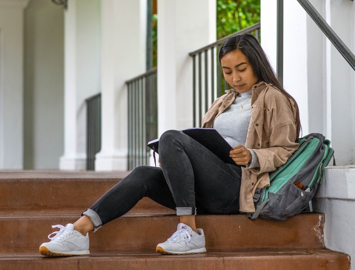 Student works on steps of SMC building