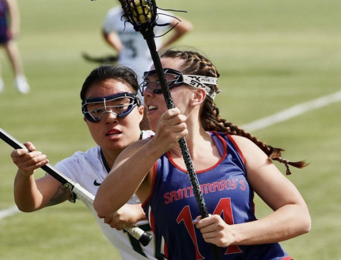 A Saint Mary's women's lacrosse player carrying the ball