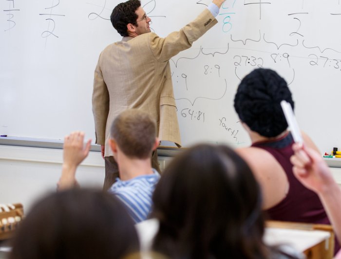 teacher writing on white board