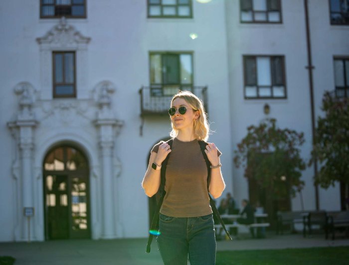 A student walking on campus 