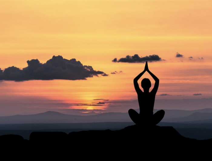 Yoga pose in front of a sunset