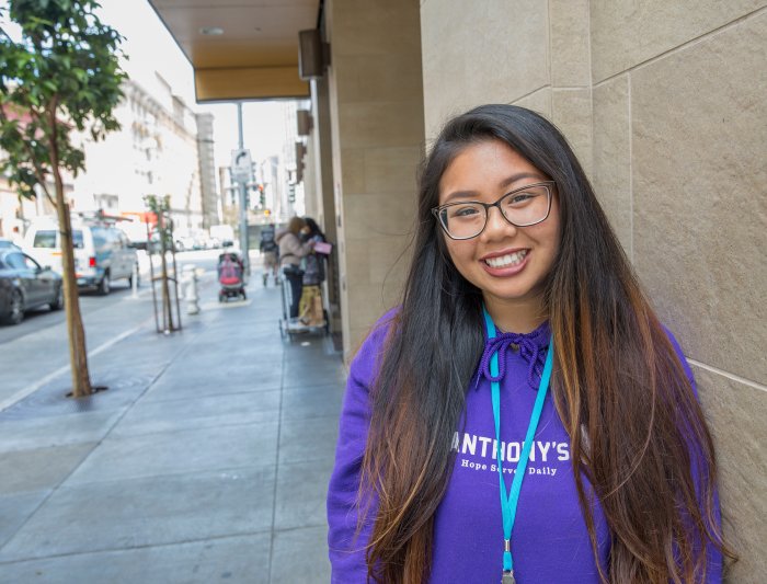 Student standing on the sidewalk in Oakland