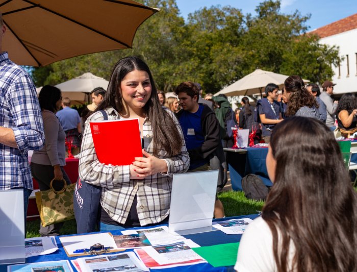 A student at Fall Preview Day at an Information Booth