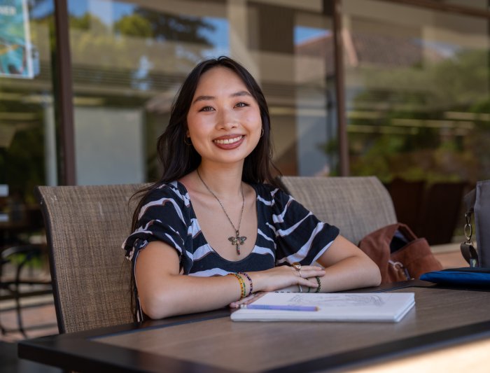Isabelle Ly sitting outside library