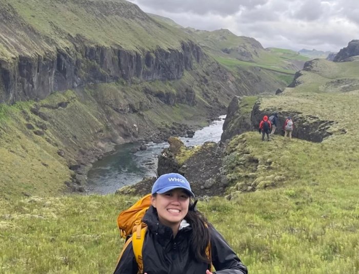 Student Aruna Silva in front of a fjord in Iceland