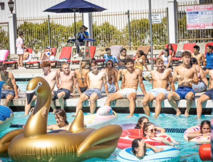 Entertaining the Crowd: First-year students gather around the pool deck to watch the silly games and fun during the Weekend of Welcome Pool Party. / Photo By Rebecca Harper