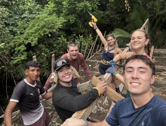 Students working on a roof in the Amazon