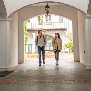 Two students walk down corridor on SMC's campus