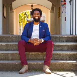 A counseling student on the stairs by the chapel breezeway