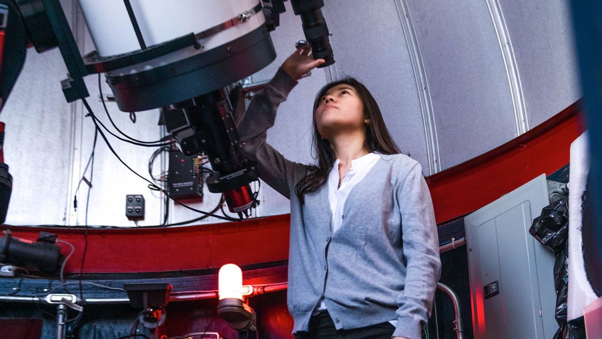 Person looking through large telescope