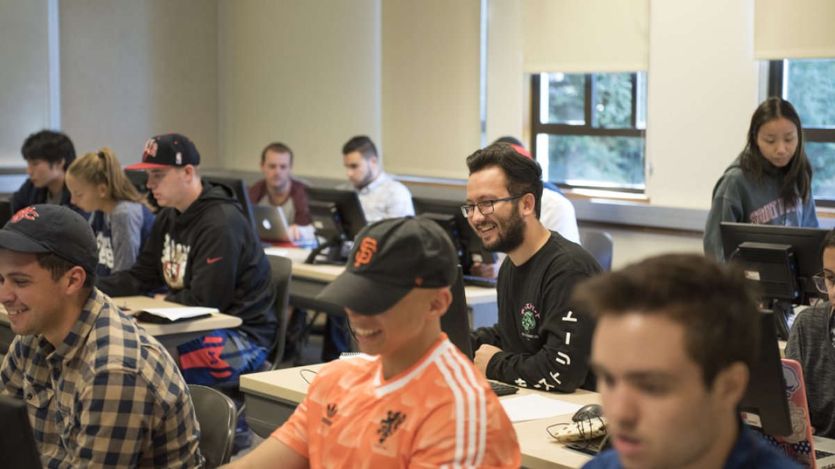 Students in a computer lab smiling 
