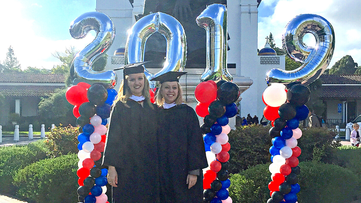 Lauren Breen and Nicole Haskins in front of the Saint Mary's chapel, 2019 graduation ceremony.