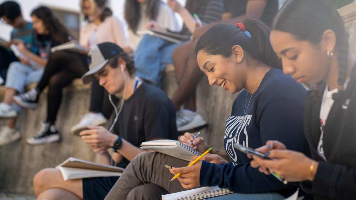 students taking notes in an outside class