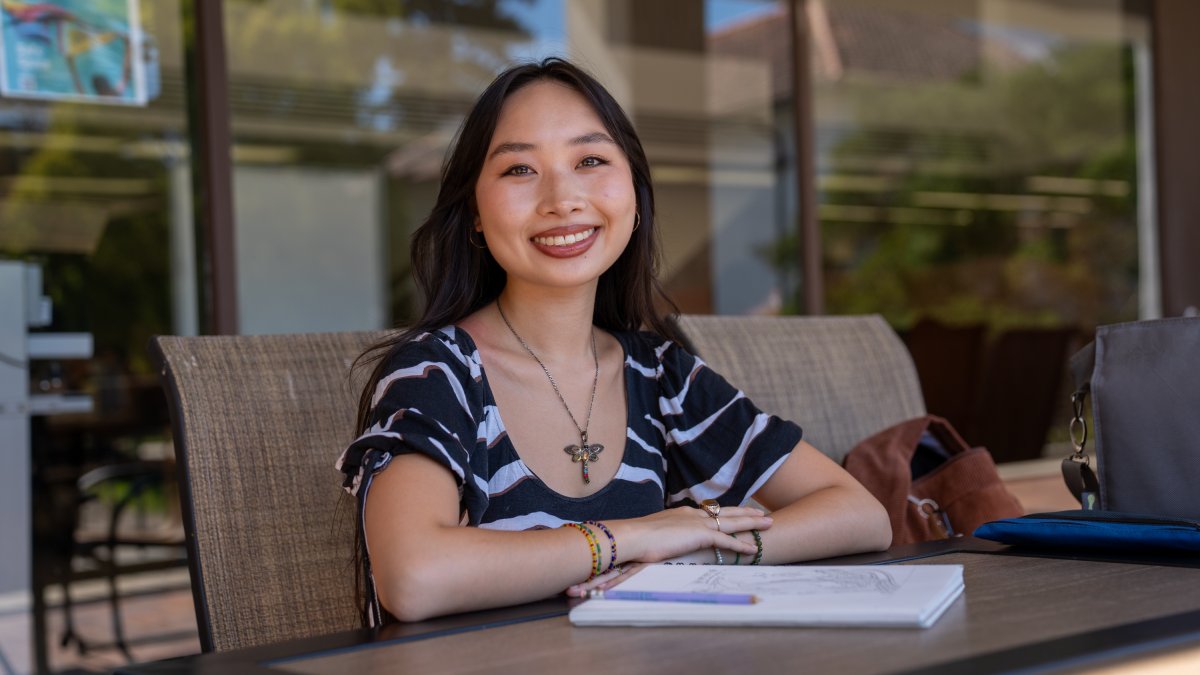 Isabelle Ly sitting outside library