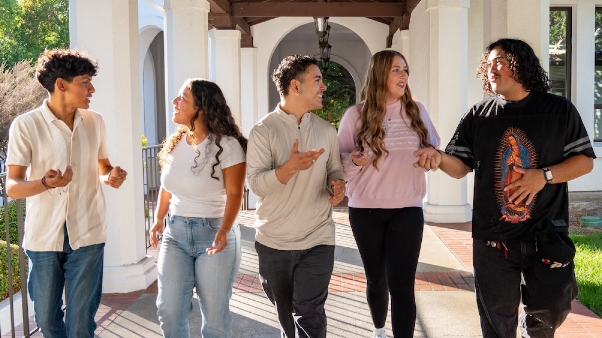 students walking in arcade by Brother Jerome West Hall in fall 2025
