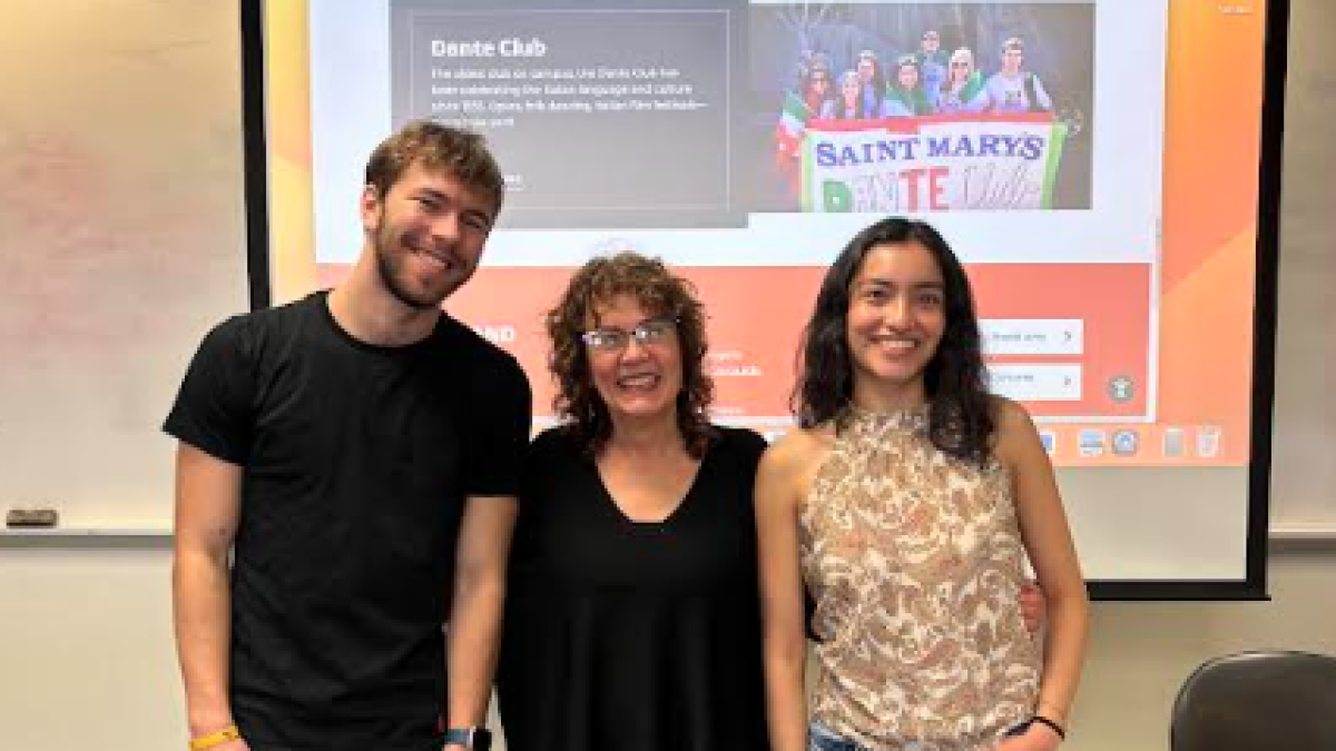 Two students with Italian Professor in classroom