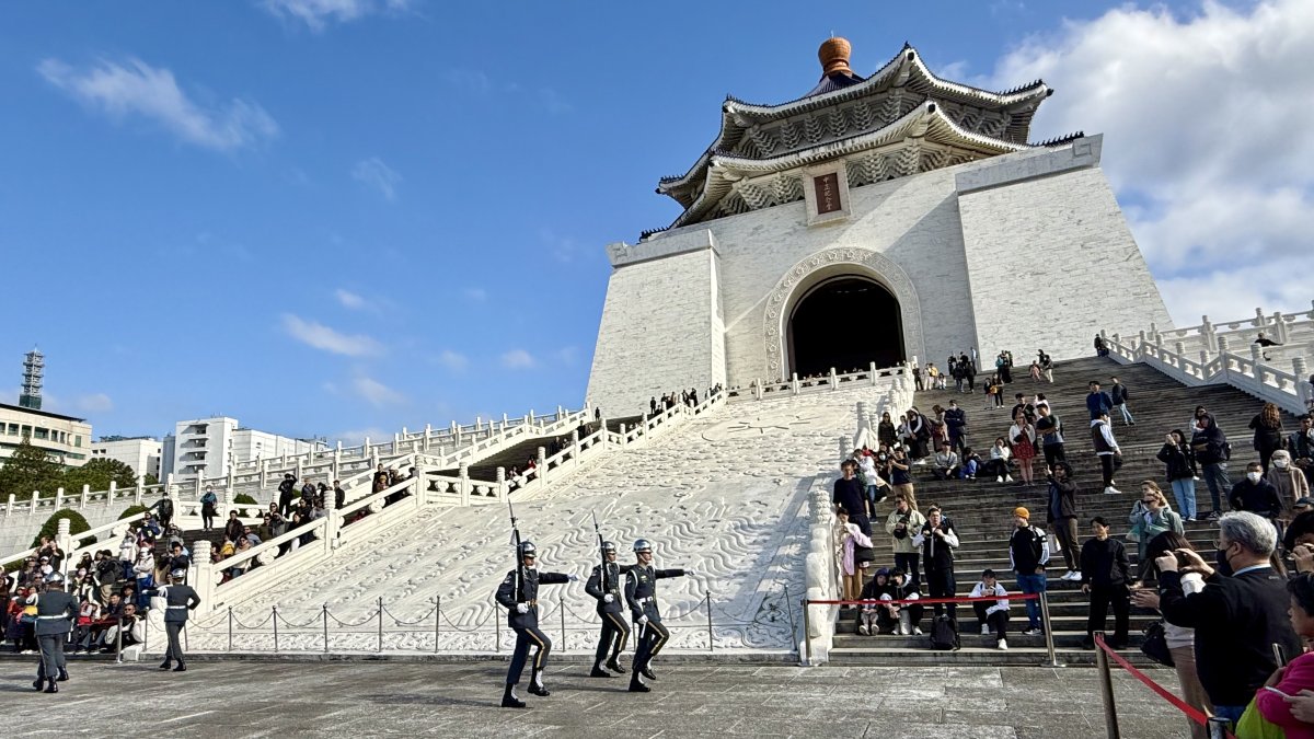 Soldiers marching in front of building